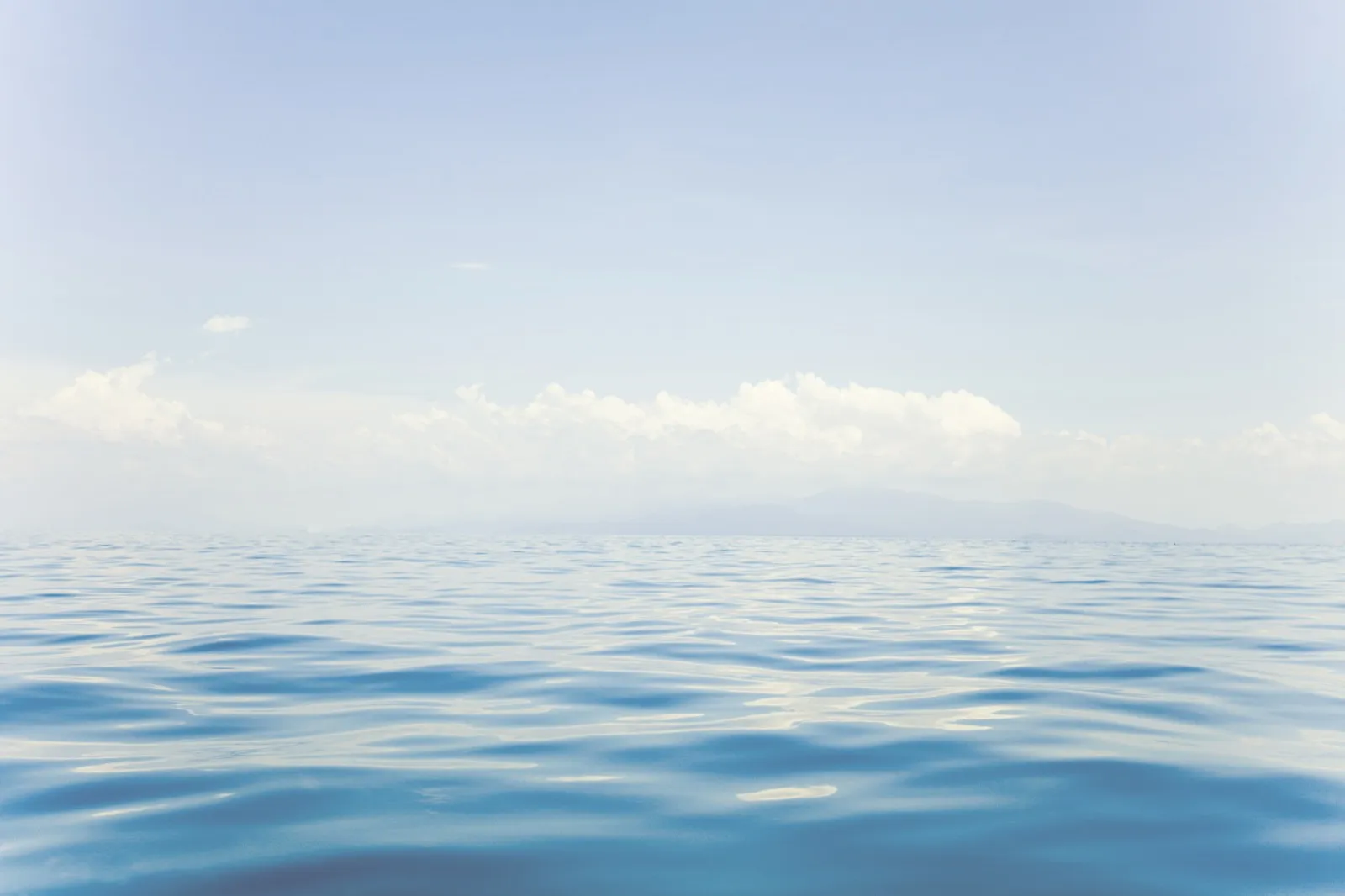 Calm open water beneath a clear sky
